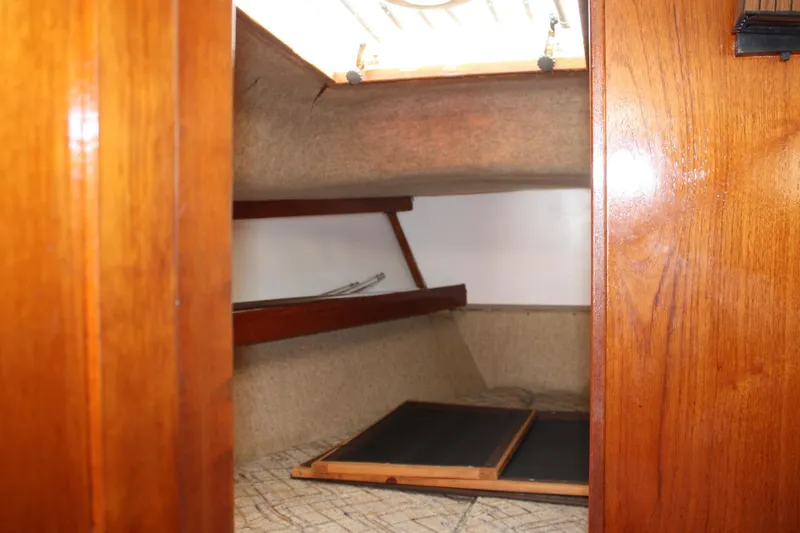 Slide: The Image of Interior cabin view of 1981 S2 9.2A sailboat with wooden finish and storage space. - 17