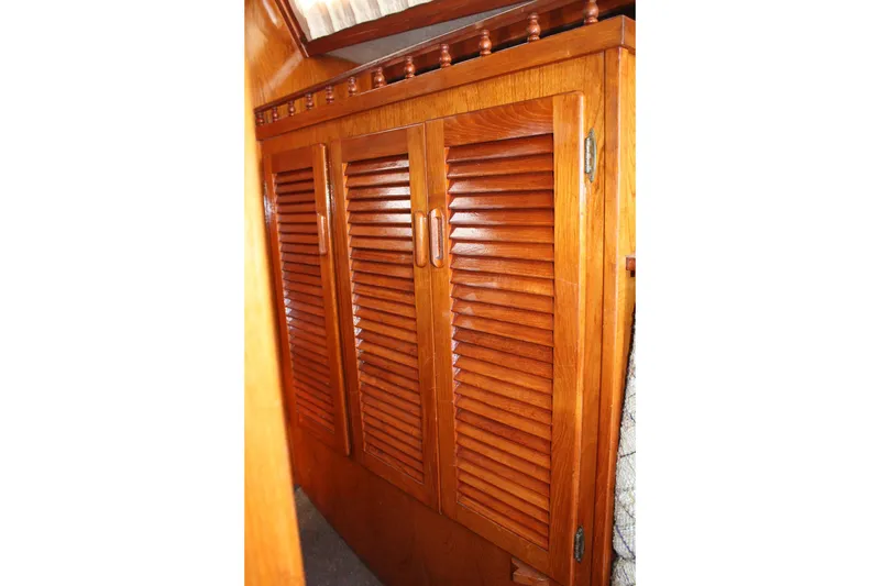 Slide: The Image of Wooden louvered cabinet doors inside a 1981 S2 9.2A sailboat interior. - 20