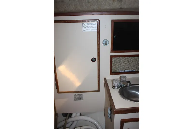 Slide: The Image of Interior of 1981 S2 9.2A sailboat showing sink, cabinet, and mirror. - 21