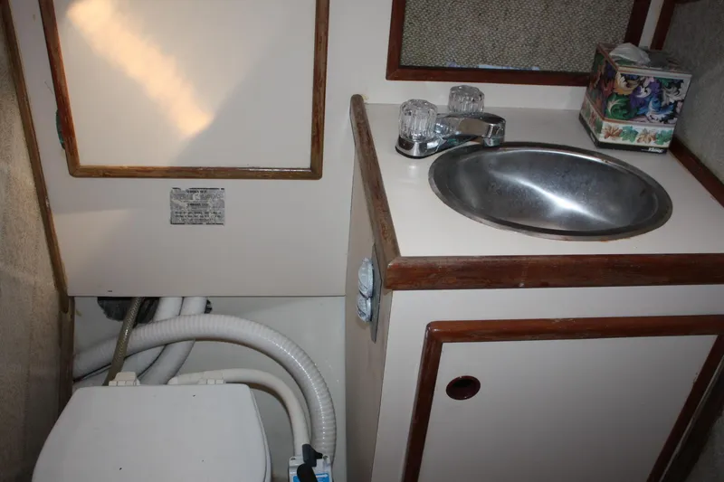 Slide: The Image of Compact bathroom in 1981 S2 9.2A sailboat with sink and toilet. - 22