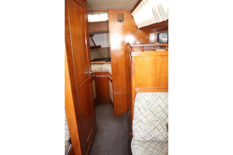 Slide: The Image of Interior of 1981 S2 9.2A sailboat with wooden cabinetry and cozy seating area. - 23