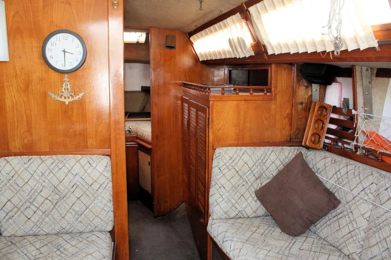 Slide: The Image of Interior of 1981 S2 9.2A sailboat with wooden paneling and cushioned seating. - 24