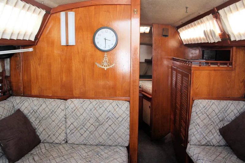 Slide: The Image of Interior of 1981 S2 9.2A sailboat with wood paneling and cushioned seating. - 25