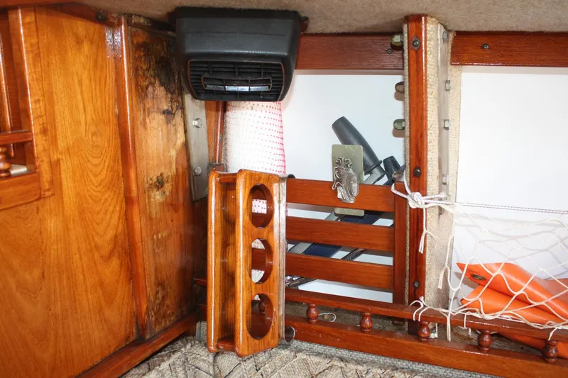 Slide: The Image of Interior of 1981 S2 9.2A sailboat with wooden cabinetry and storage compartments. - 27
