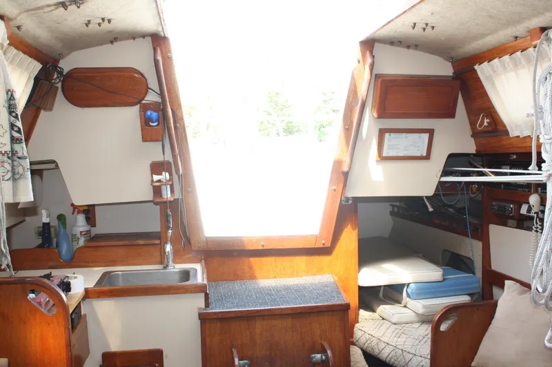 Slide: The Image of Interior of a 1981 S2 9.2A sailboat featuring a compact kitchen and cozy seating area. - 28