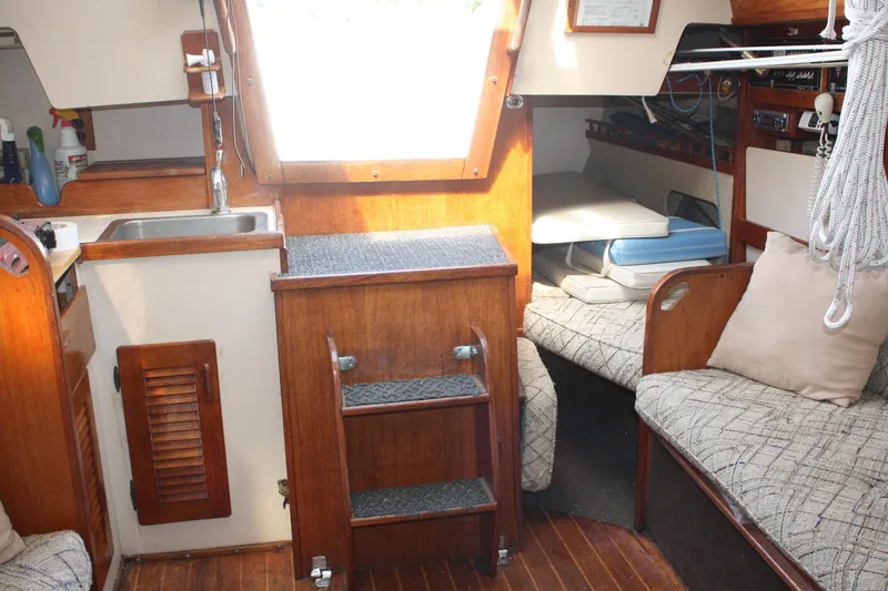 Slide: The Image of Interior of a 1981 S2 9.2A sailboat featuring a cozy cabin with wood accents. - 29