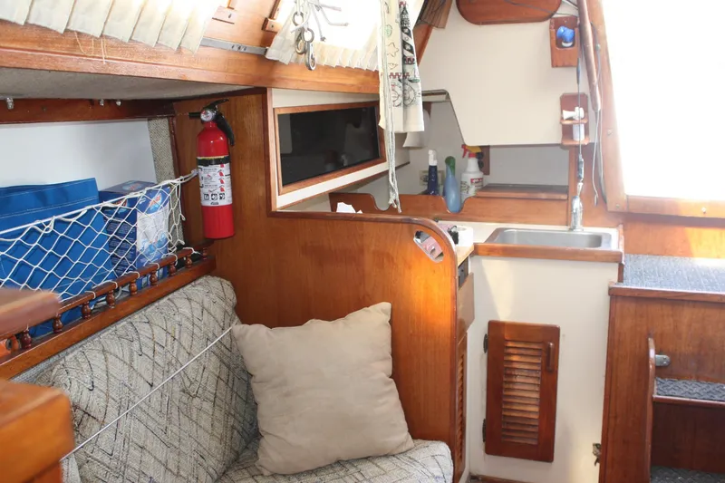 Slide: The Image of Interior of a 1981 S2 9.2A sailboat featuring a cozy cabin and kitchenette. - 30