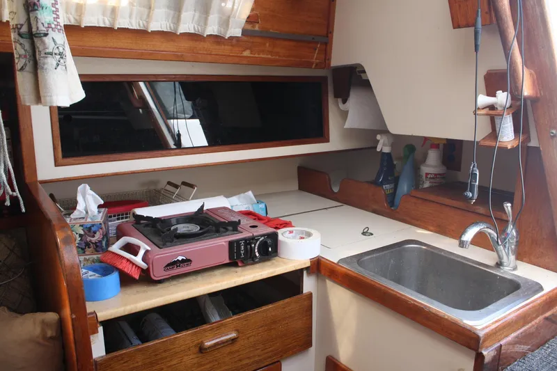Slide: The Image of 1981 S2 9.2A sailboat galley with stove, sink, and storage. - 35