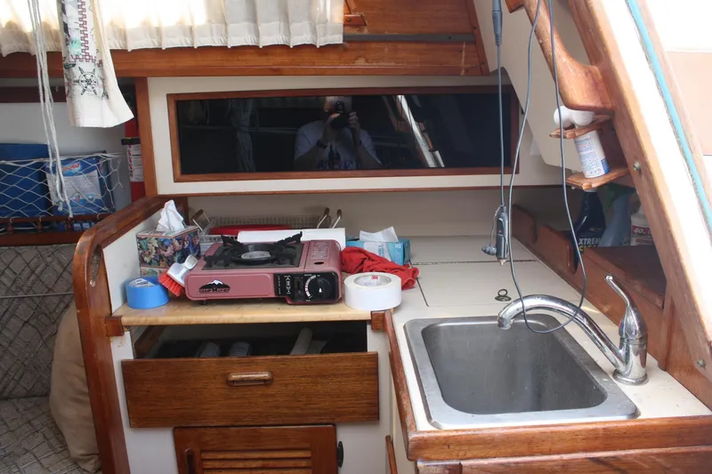 Slide: The Image of Compact kitchen area in a 1981 S2 9.2A sailboat with stove and sink. - 36
