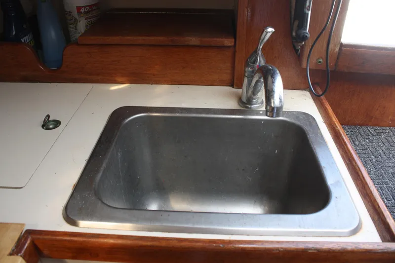 Slide: The Image of Stainless steel sink in 1981 S2 9.2A boat galley with wooden trim. - 38