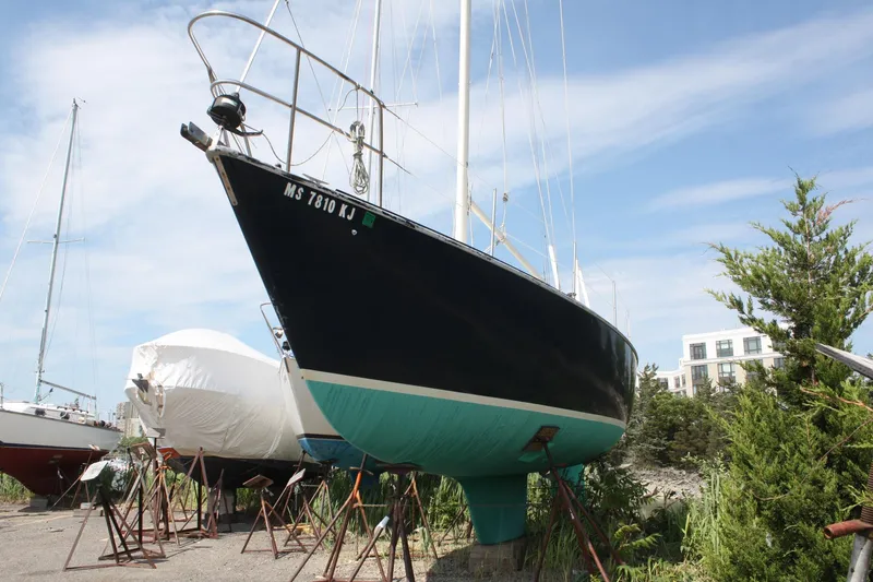 Slide: The Image of 1981 S2 9.2A sailboat on stands, with blue hull and clear sky background. - 4