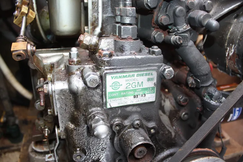 Slide: The Image of Close-up of a Yanmar Diesel 2GM engine, showcasing mechanical components and label details. - 46