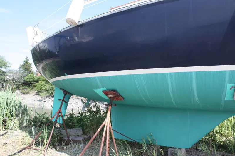 Slide: The Image of 1981 S2 9.2A sailboat on stands, blue hull, outdoors. - 5