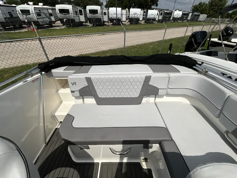 Slide: The Image of The image shows the cockpit of a 2023 Bayliner VR5 with gray upholstery and a table. - 6