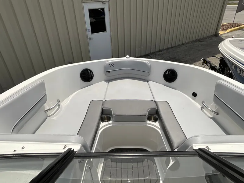 Slide: The Image of The image shows the bow area of a 2023 Bayliner VR5 boat with gray upholstery. - 11