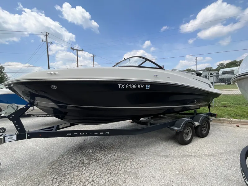 The Image of A 2023 Bayliner VR5 on a trailer, featuring a black hull and white deck. - 1