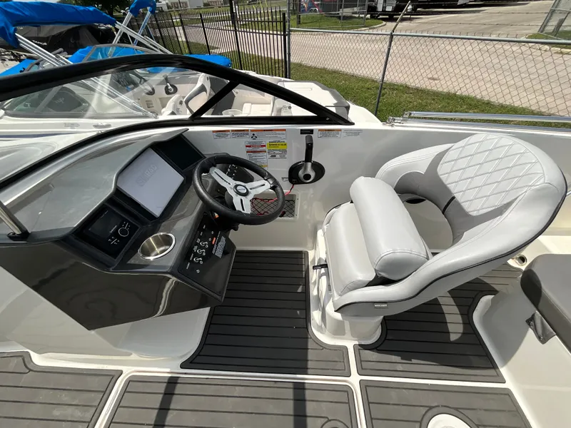Slide: The Image of The image shows the cockpit of a 2023 Bayliner VR5 with a sleek steering wheel and cushioned seat. - 8