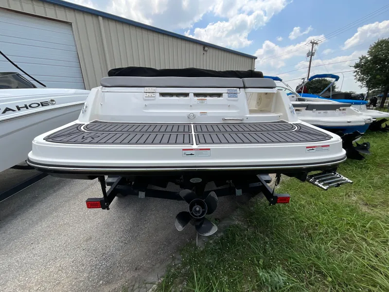 Slide: The Image of The image shows the rear of a 2023 Bayliner VR5 boat with a black deck. - 4