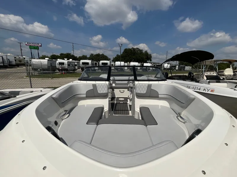Slide: The Image of The image shows the cockpit of a 2023 Bayliner VR5 with gray upholstery and sleek lines. - 12