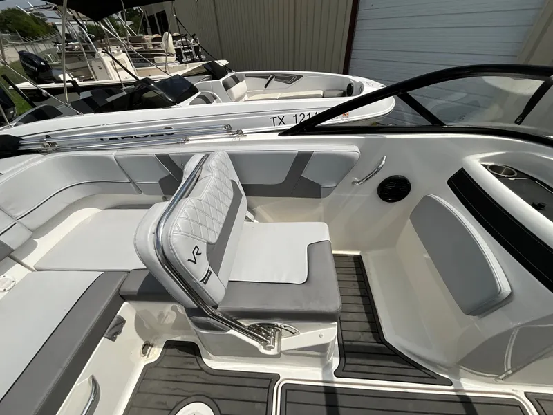 Slide: The Image of The image shows the cockpit of a 2023 Bayliner VR5 with gray and white seating. - 7