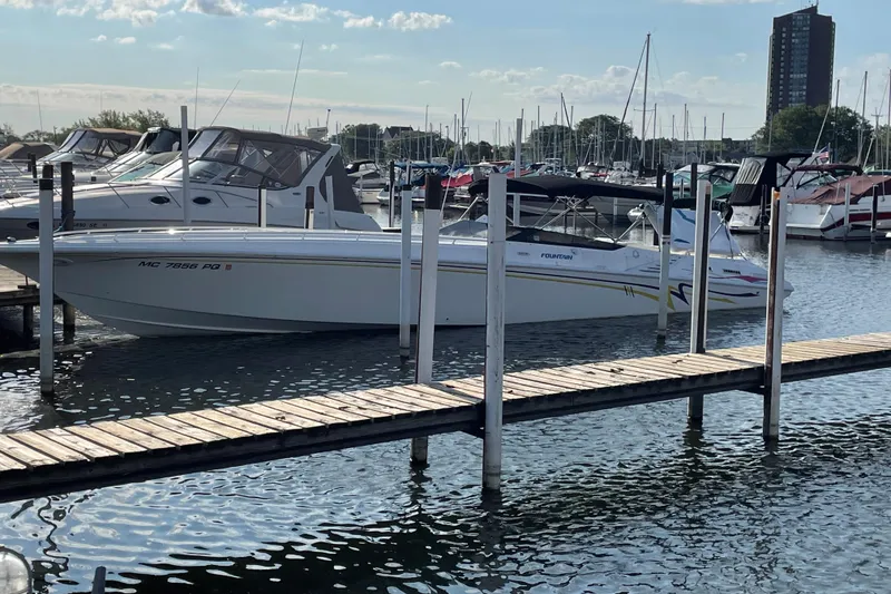The Image of 1994 Fountain 42 Lightning boat docked in a marina, surrounded by other vessels. - 0