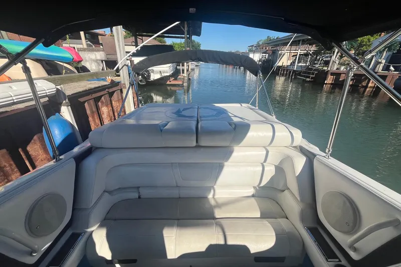 Slide: The Image of 1994 Fountain 42 Lightning boat interior with white seating, docked in a serene canal. - 11