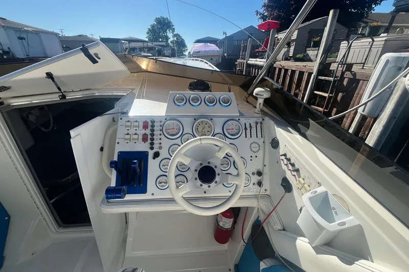 Slide: The Image of Cockpit of a 1994 Fountain 42 Lightning boat with steering wheel and gauges. - 12