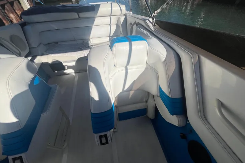 Slide: The Image of Interior of a 1994 Fountain 42 Lightning boat with white and blue seating. - 14