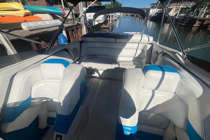Slide: The Image of 1994 Fountain 42 Lightning boat interior with white and blue seating, docked by the water. - 15