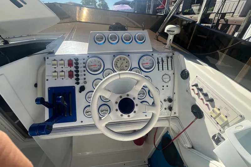 Slide: The Image of Cockpit of a 1994 Fountain 42 Lightning boat with gauges and steering wheel. - 16