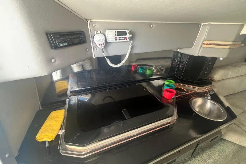 Slide: The Image of Interior of a 1994 Fountain 42 Lightning boat with kitchenette and radio equipment. - 18