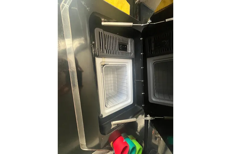 Slide: The Image of Open storage compartment in a 1994 Fountain 42 Lightning boat, showing interior details. - 19