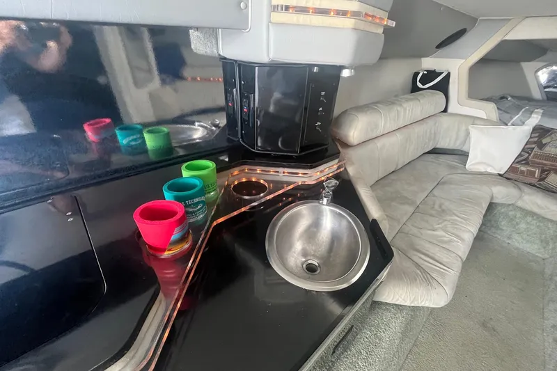 Slide: The Image of Interior of a 1994 Fountain 42 Lightning boat with sink and seating area. - 21