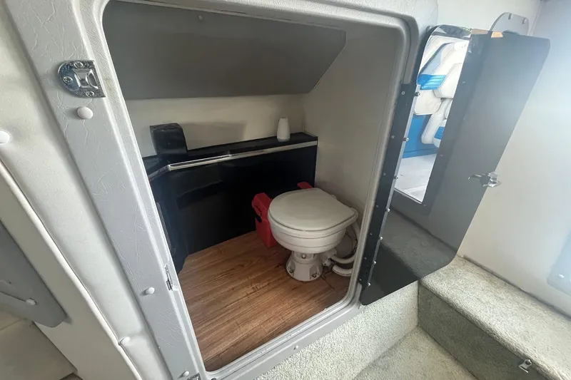 Slide: The Image of Interior of 1994 Fountain 42 Lightning boat featuring compact bathroom with toilet. - 23