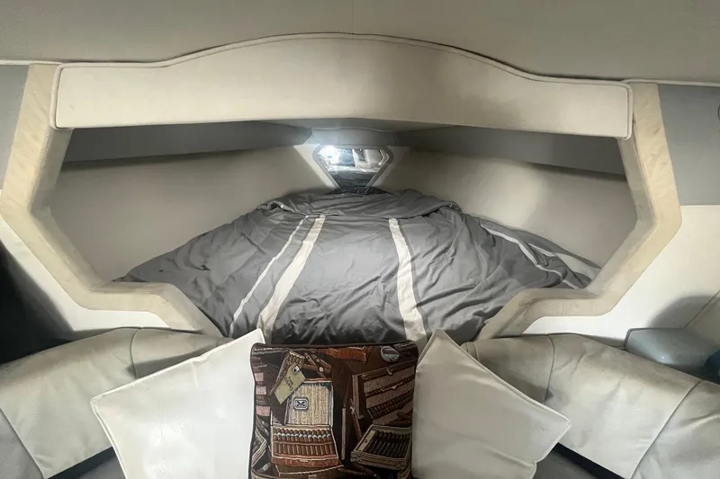 Slide: The Image of Interior cabin of a 1994 Fountain 42 Lightning boat with cozy bedding and cushions. - 26