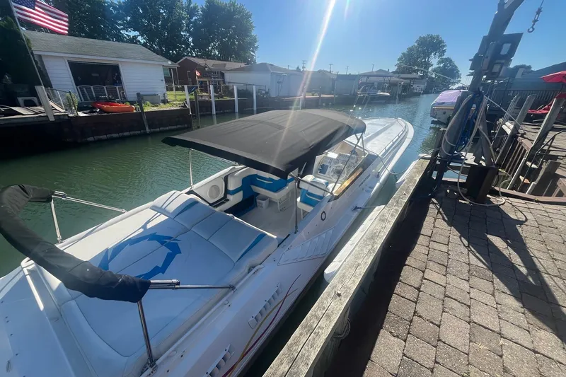Slide: The Image of 1994 Fountain 42 Lightning boat docked in a sunny canal setting. - 3