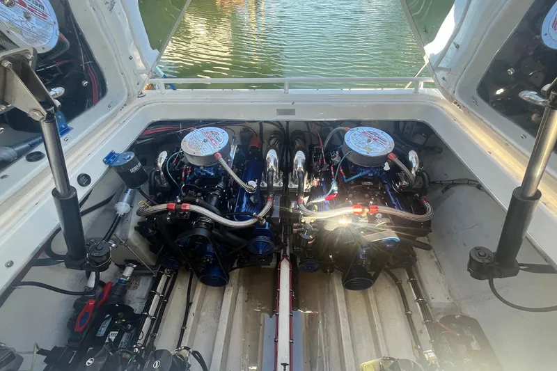Slide: The Image of Engine compartment of a 1994 Fountain 42 Lightning boat, showcasing dual engines. - 30