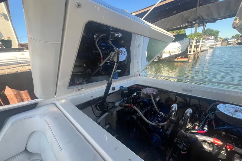 Slide: The Image of 1994 Fountain 42 Lightning boat engine compartment open by the water. - 33
