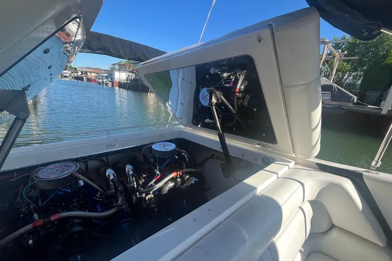 Slide: The Image of Engine compartment of a 1994 Fountain 42 Lightning boat, open by the water. - 34