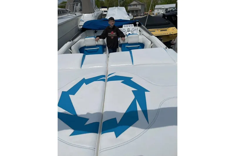 Slide: The Image of 1994 Fountain 42 Lightning boat with blue and white interior, person standing at helm. - 8