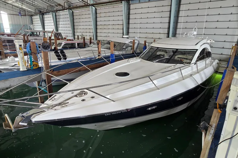 The Image of 2004 Sunseeker Camargue 50 yacht docked in a marina, showcasing sleek design and luxury. - 1
