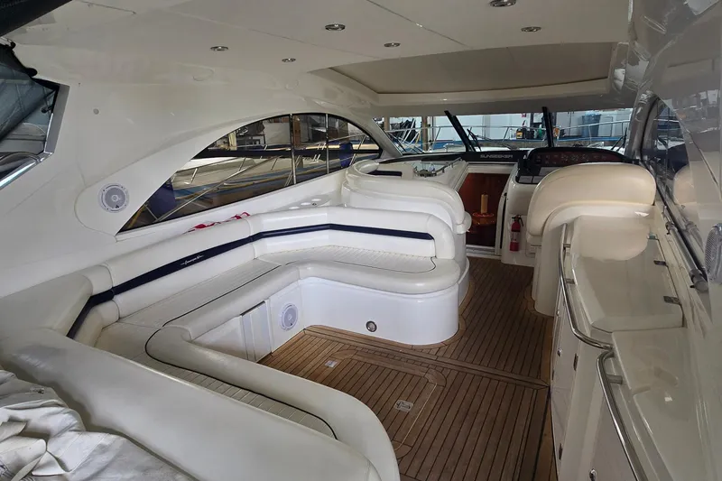 Slide: The Image of Luxurious 2004 Sunseeker Camargue 50 yacht interior with elegant seating and wood flooring. - 10