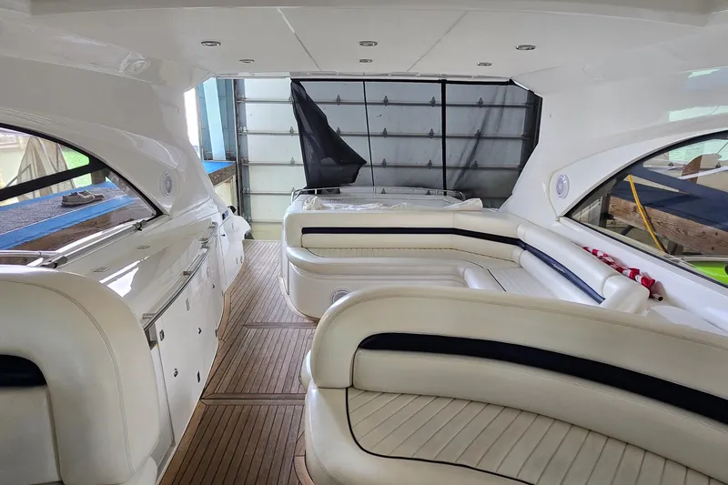 Slide: The Image of Interior of 2004 Sunseeker Camargue 50 yacht with elegant white seating and wood flooring. - 11