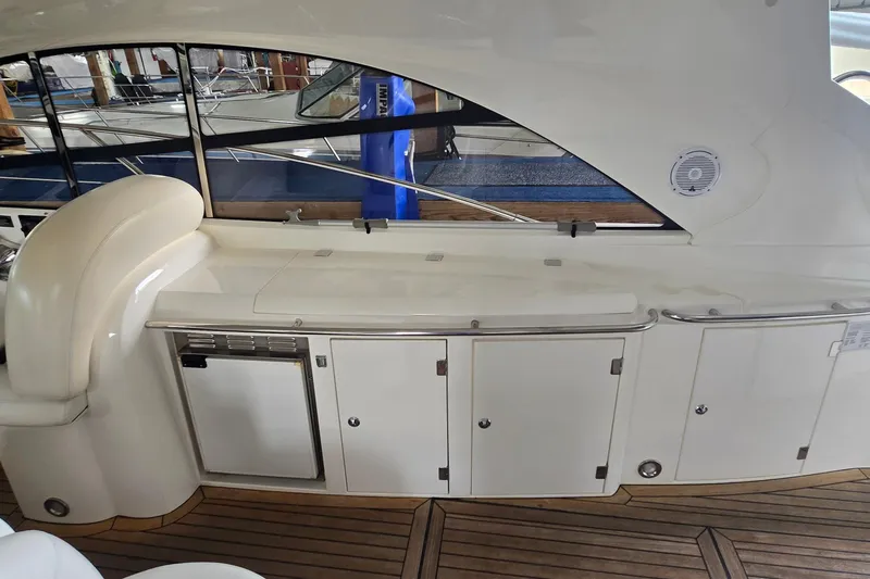 Slide: The Image of 2004 Sunseeker Camargue 50 yacht interior with sleek cabinetry and wooden flooring. - 14