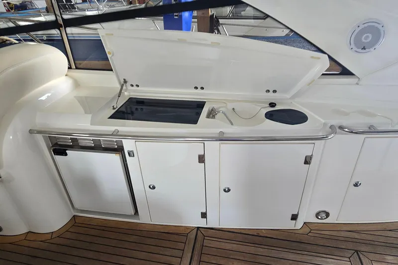 Slide: The Image of Outdoor kitchenette on a 2004 Sunseeker Camargue 50 yacht with sink and storage. - 15