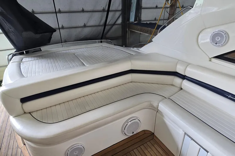 Slide: The Image of Luxurious seating area on a 2004 Sunseeker Camargue 50 yacht, featuring elegant white upholstery. - 16
