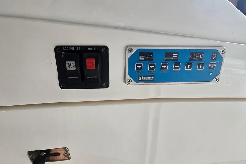 Slide: The Image of Control panel of a 2004 Sunseeker Camargue 50 yacht with labeled switches and buttons. - 17