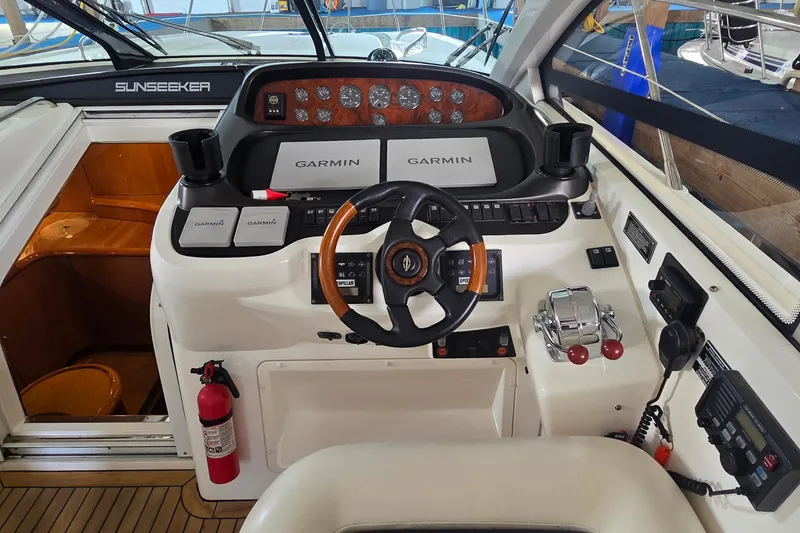 Slide: The Image of Cockpit of 2004 Sunseeker Camargue 50 with Garmin navigation system and steering wheel. - 21