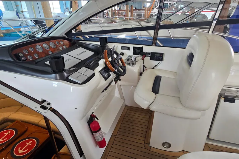 Slide: The Image of Helm of 2004 Sunseeker Camargue 50 yacht with Garmin navigation and luxurious seating. - 23