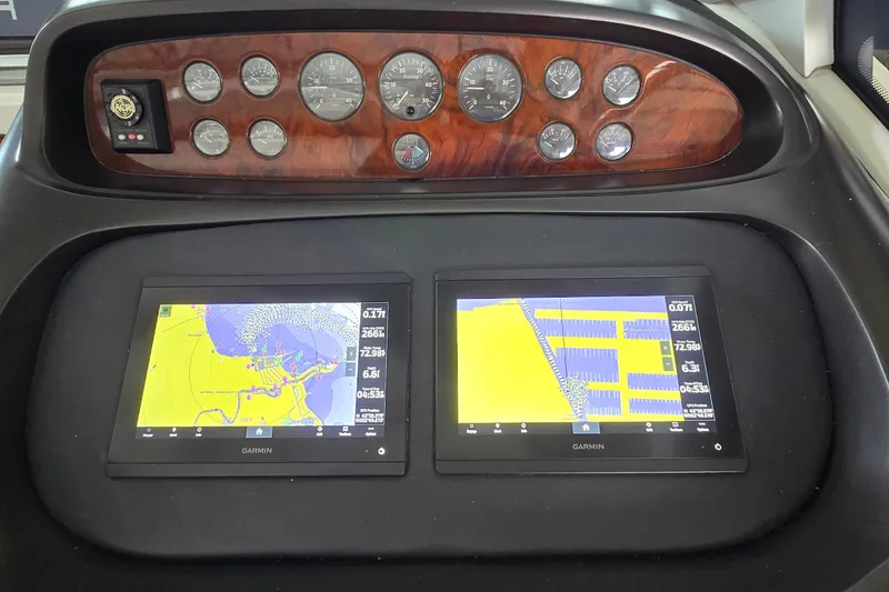 Slide: The Image of Dashboard of 2004 Sunseeker Camargue 50 with Garmin navigation displays and analog gauges. - 27